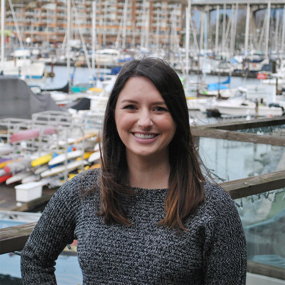 Lauren Maynard Headshot A headshot photo of Lauren Maynard, Speech-Language Pathologist at Granville Island Speech. She stands in front of boats and the pier at Granville Island outside of the clinic.